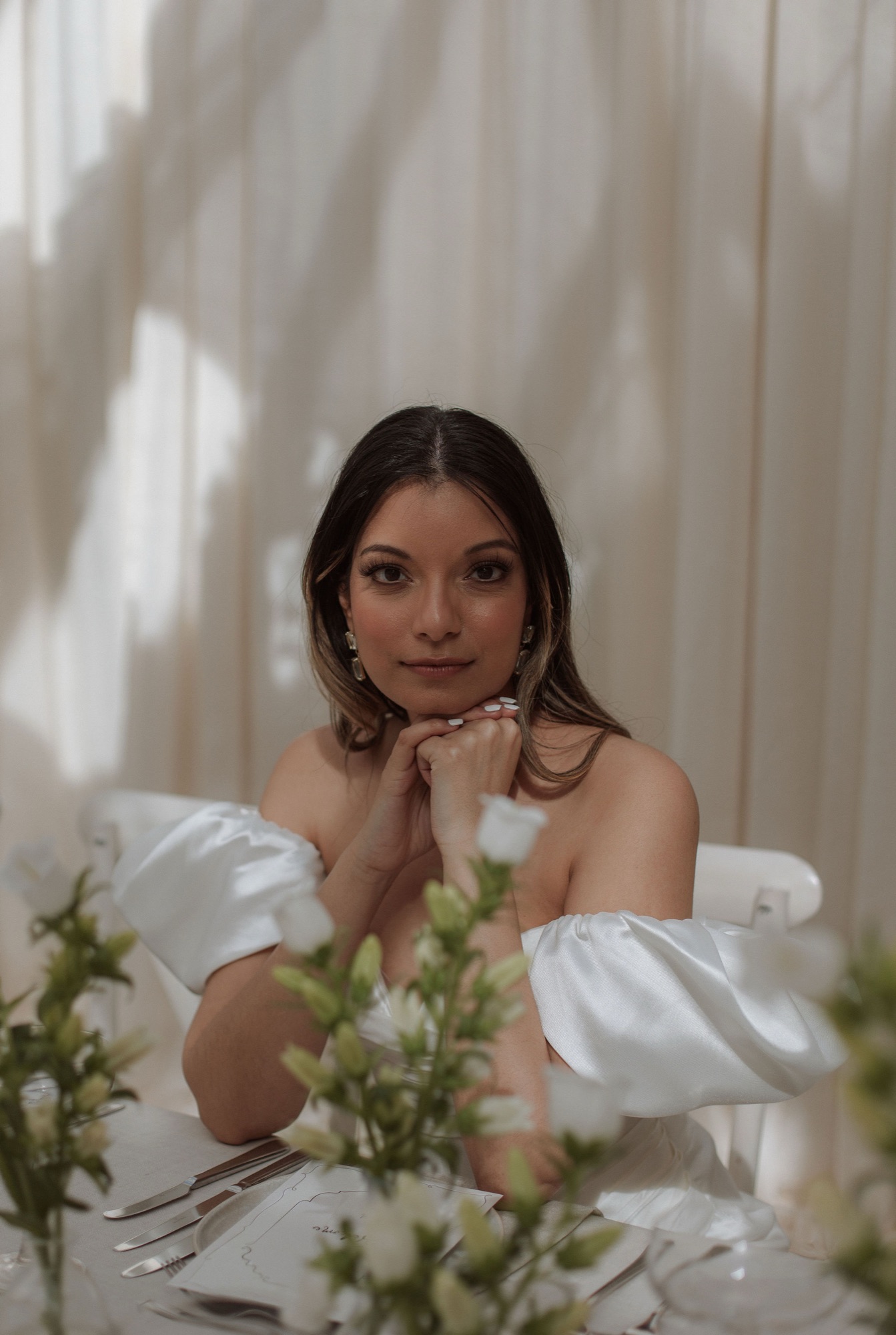 Styled bridal portrait — bride at a table with white florals